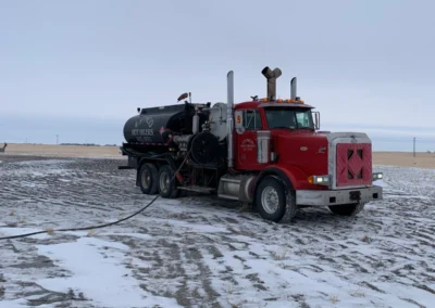 Oilfield hot oiler truck working with visible exhaust and steam